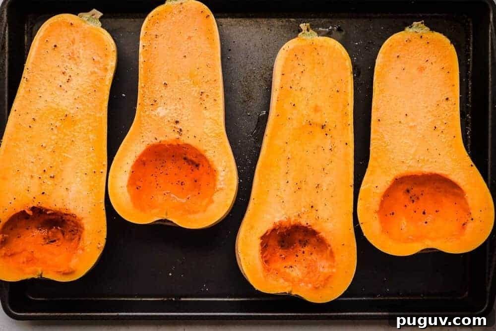 butternut squash halves oiled on baking sheet