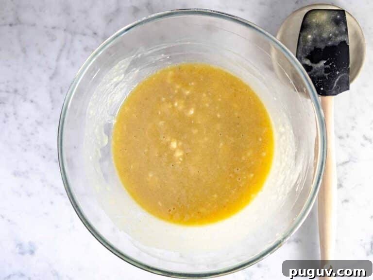 Moist Banana Bread Recipe with Whole Grain and Yogurt 12 wet ingredients in a bowl