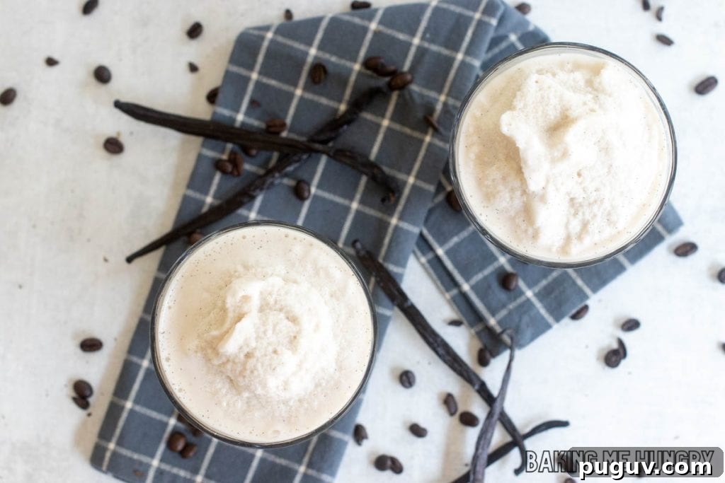 Copycat Vanilla Coffee Frappuccino Recipe for Cafe-Style Blended Drink 8 vanilla coffee frappuccino recipe in two glasses from overhead with vanilla beans and coffee beans on white surface