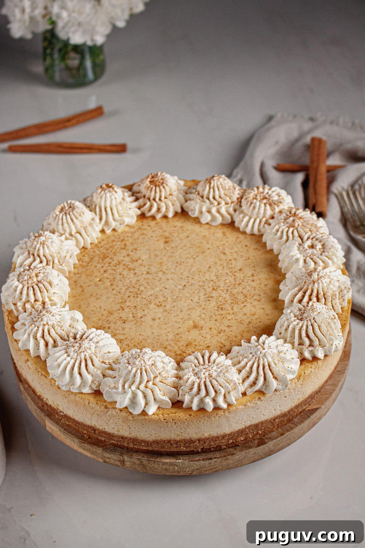 Decadent RumChata Cheesecake Recipe: Creamy Liqueur Dessert 3 Cheesecake topped with whipped cream.
