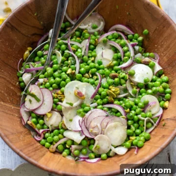 Minted Pea and Radish Salad with Lemon Vinaigrette 6 big wood bowl filled with healthy pea salad with radishes, red onions, mint and pistachios