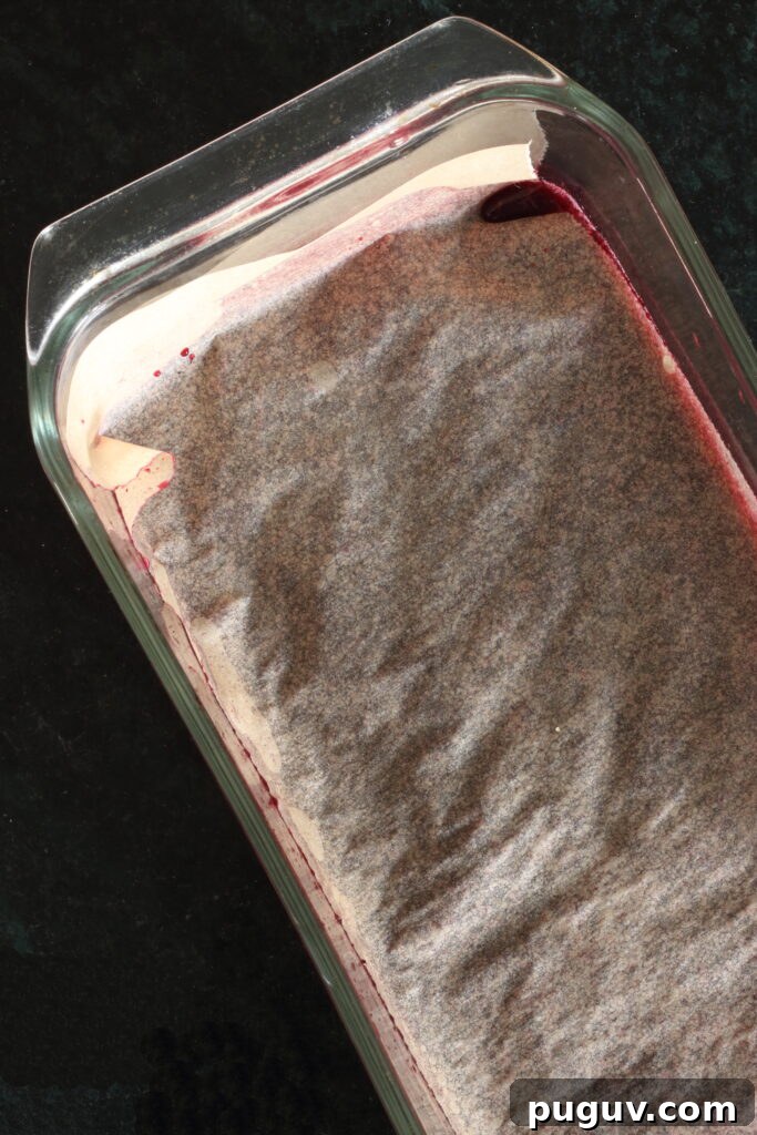 Blueberry "freeze & stir" sorbet in glass loaf pan; sorbet is covered with parchment paper