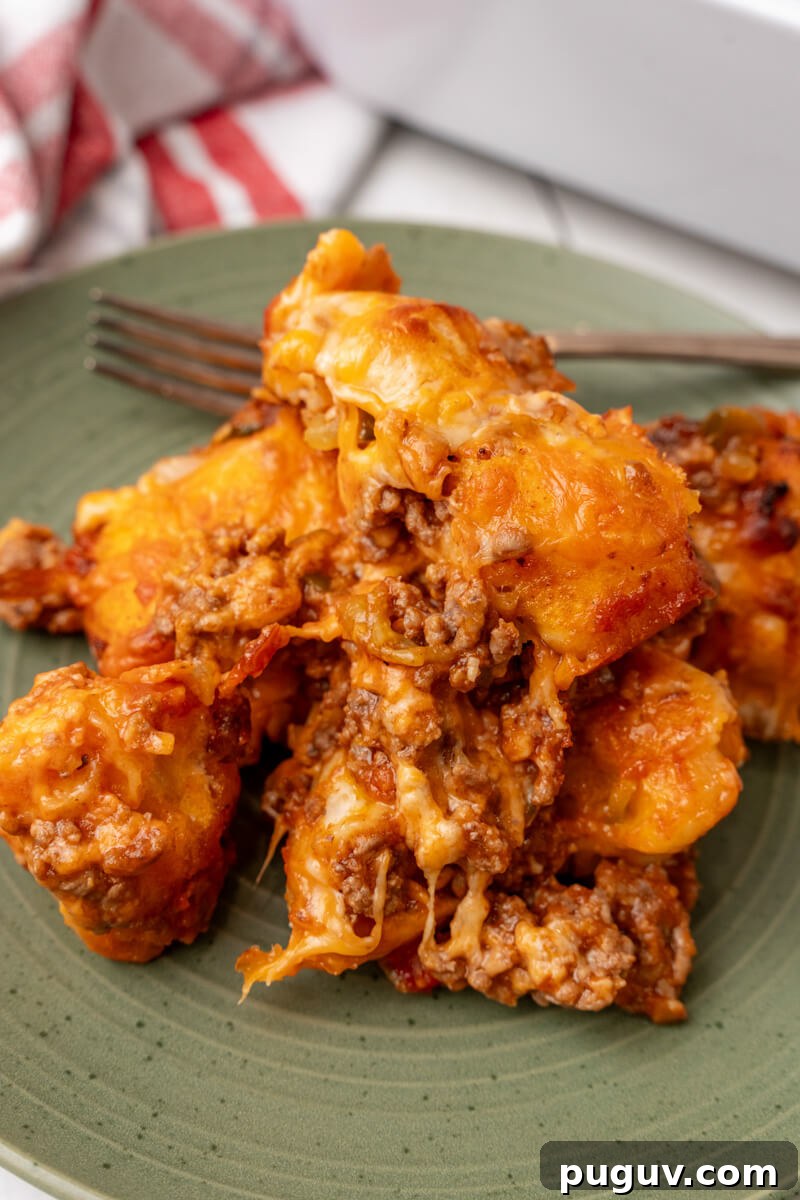A serving of sloppy joe biscuit casserole on a green plate.