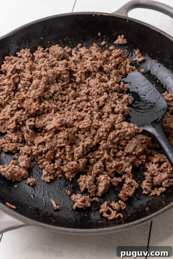 Ground beef is browned in a pan.