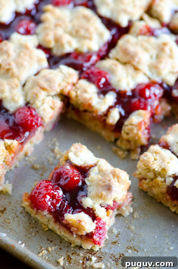 Apple Butter Cherry Cobbler Bars - These cherry cobbler bars have added depth of flavor with a secret ingredient. Simple and sweet with cherry pie filling and the great, unique taste of Musselman's Apple Butter.