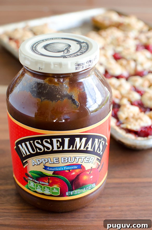 Apple Butter Cherry Cobbler Bars Recipe — Sweet Autumn Dessert 4 Apple Butter Cherry Cobbler Bars - These cherry cobbler bars have added depth of flavor with a secret ingredient. Simple and sweet with cherry pie filling and the great, unique taste of Musselman's Apple Butter.