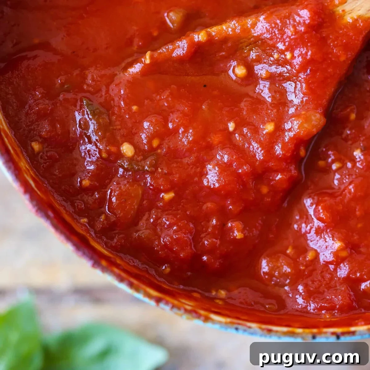 Homemade Tomato Pasta Sauce on wooden spoon.