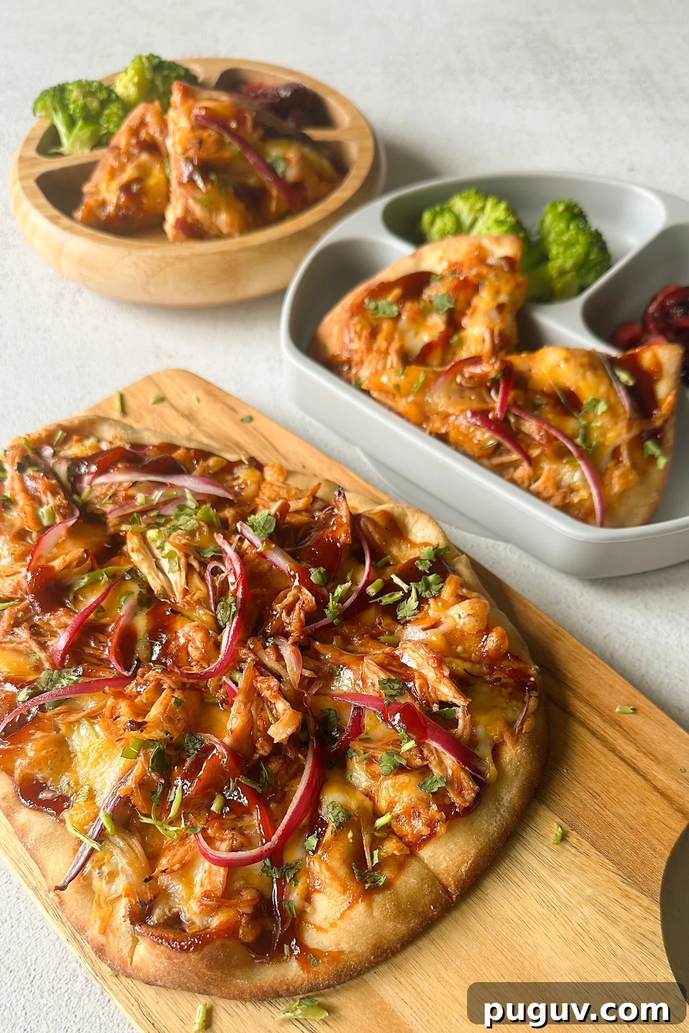 BBQ Chicken Naan Pizza Recipe: Crispy Naan, Tangy Sauce 2 BBQ chicken naan pizzas served with broccoli and cherries.