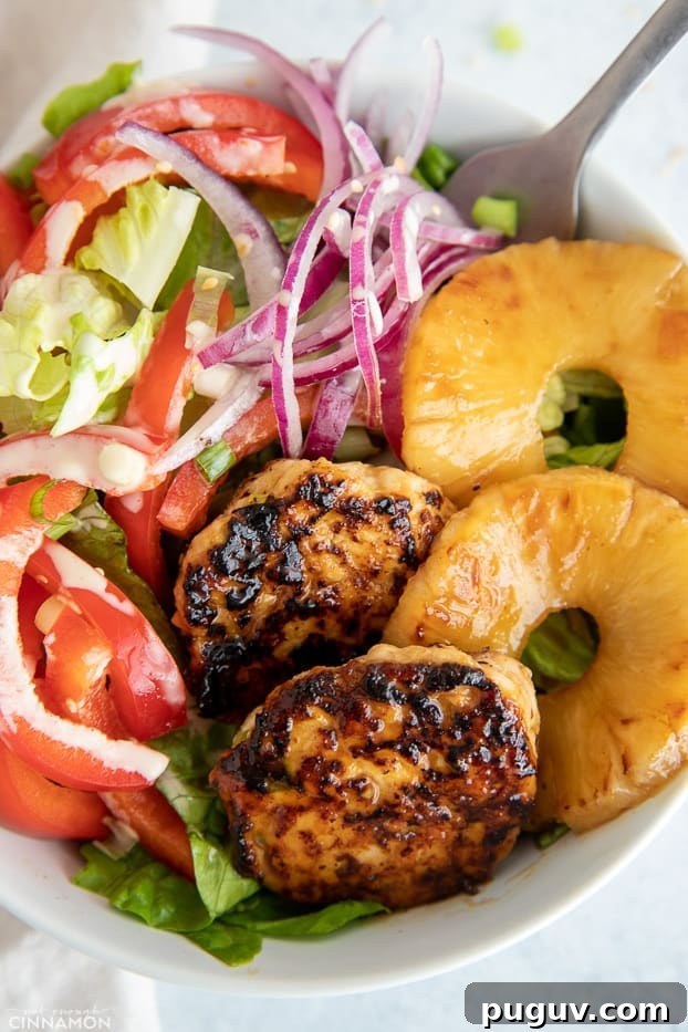 burger bowl overhead close-up of a healthy Hawaiian chicken burger bowl with juicy chicken patties and charred pineapple rings