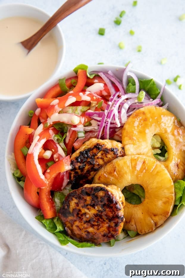 assembled bowl overhead shot of a healthy Hawaiian Chicken Burger Bowl drizzled with Whole30 teriyaki sauce