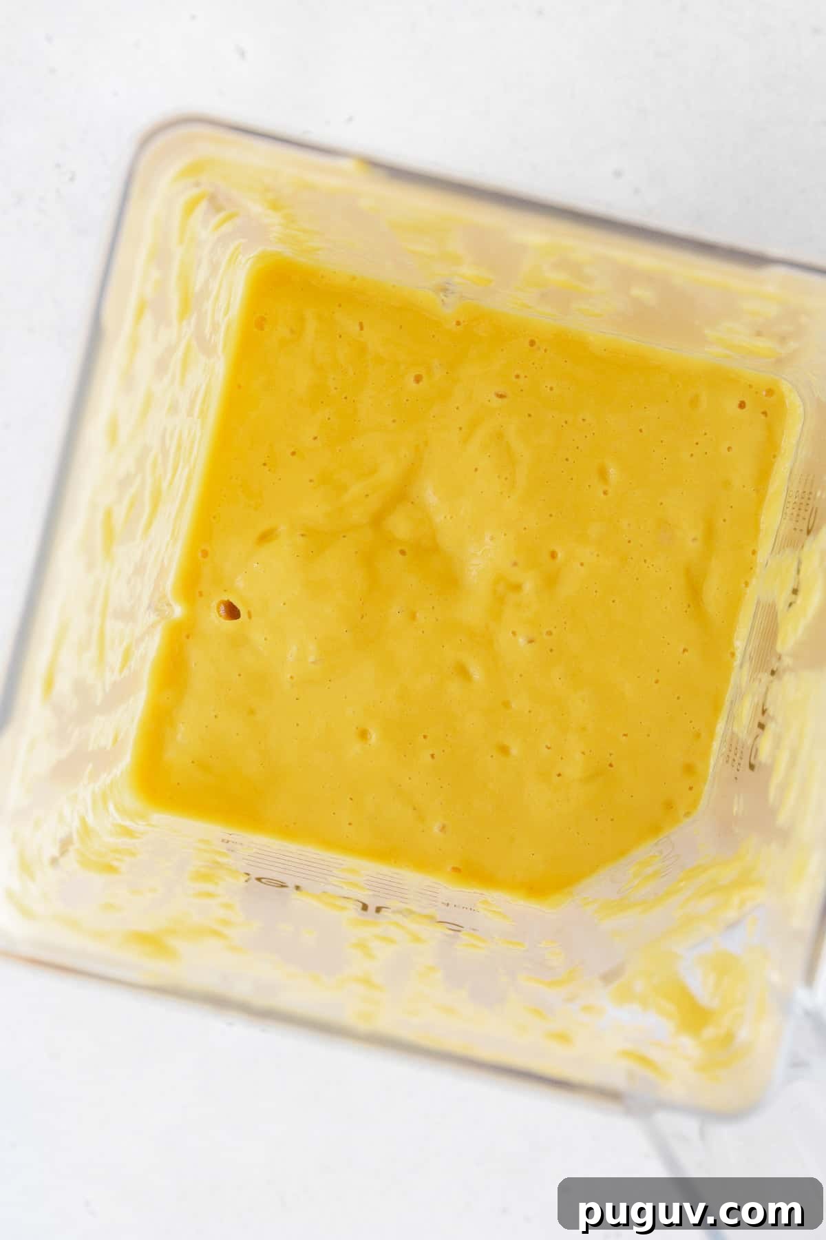 Blended up mango puree in a blender.