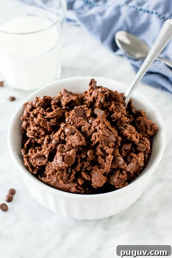 Edible Double Chocolate Cookie Dough Recipe for Safe Snacking 2 A bowl of edible double chocolate cookie dough with a spoon in it.