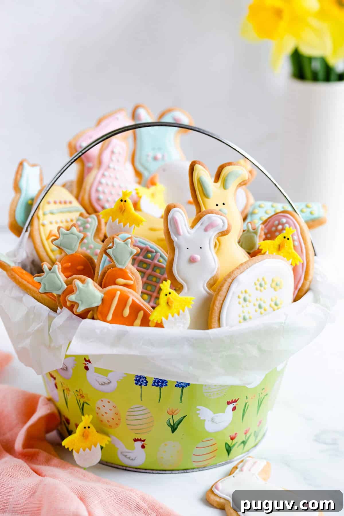 Easter Sugar Cookie Recipe with Simple Decorative Icing 2 side close up of basket filled with Easter sugar cookies with coloured icing