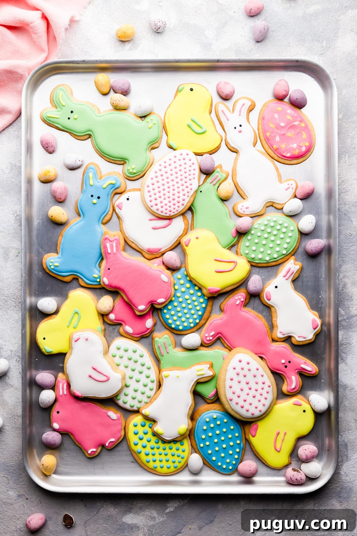 Easter Sugar Cookie Recipe with Simple Decorative Icing 11 top view at Easter sugar cookies with icing on a baking sheet