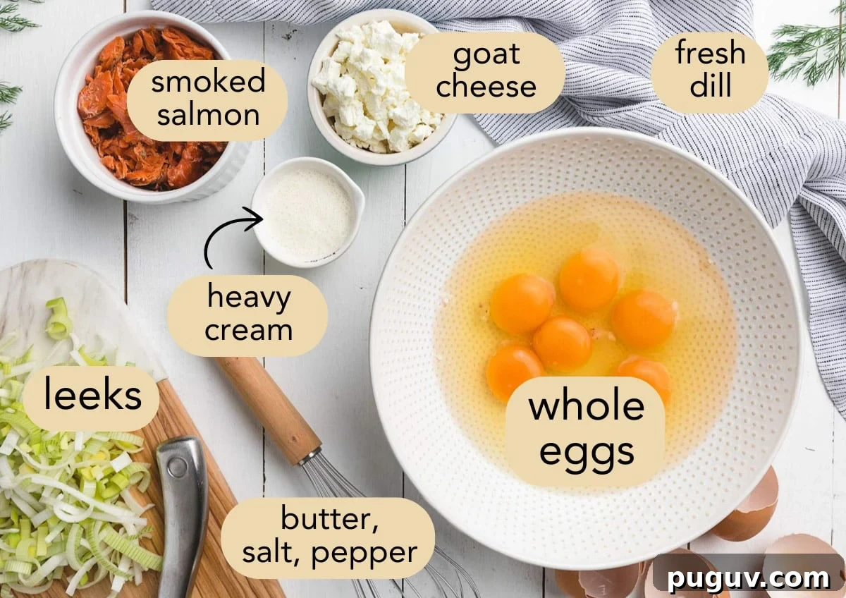 Smoked Salmon, Leek & Goat Cheese Frittata Recipe 4 overhead photo of ingredients for smoked salmon frittata in bowls on a white wood board with text label overlays