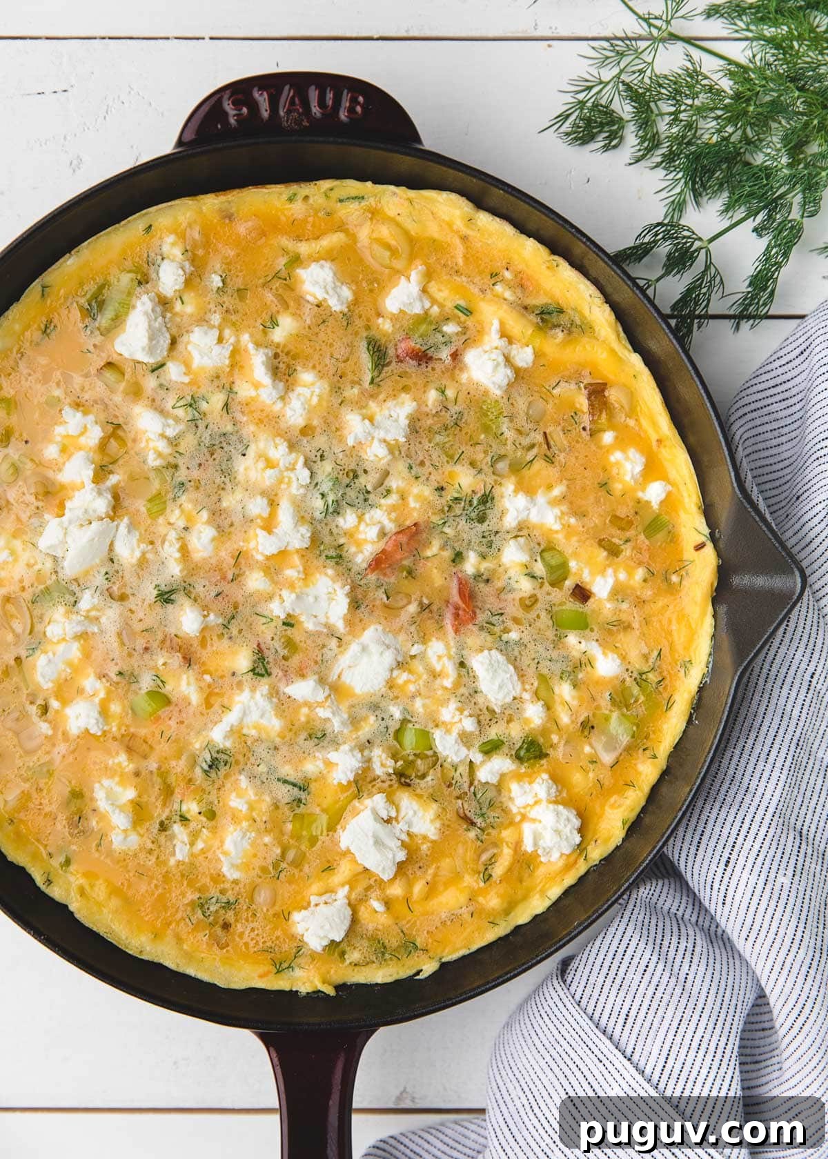 Smoked Salmon, Leek & Goat Cheese Frittata Recipe 8 overhead photo of an unbaked smoked salmon frittata in a staub frying pan