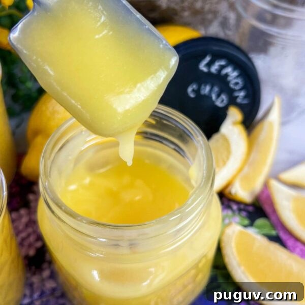 Lemon Curd with Whole Eggs: Simple Recipe and Freezing Tips 2 lemon curd on spoon over jar