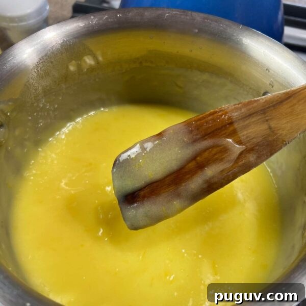 Lemon Curd with Whole Eggs: Simple Recipe and Freezing Tips 5 finger line on wooden spoon over pot