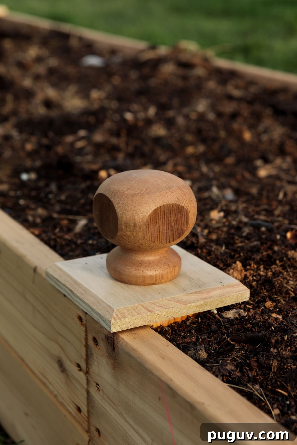 Build Raised Garden Beds: A Step-by-Step Guide for Any Yard 4 Wood end caps attached to raised garden bed filled with dark rich soil