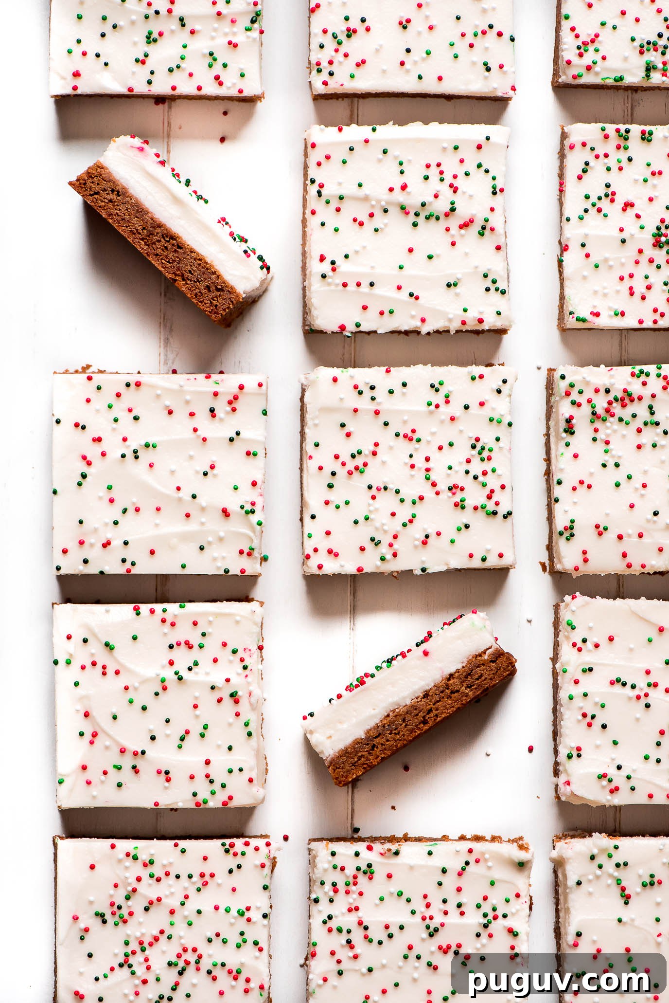 Christmas Sugar Cookie Bars topped with cream cheese frosting and sprinkles. Top view of Christmas Sugar Cookie Bars topped with cream cheese frosting and sprinkles.