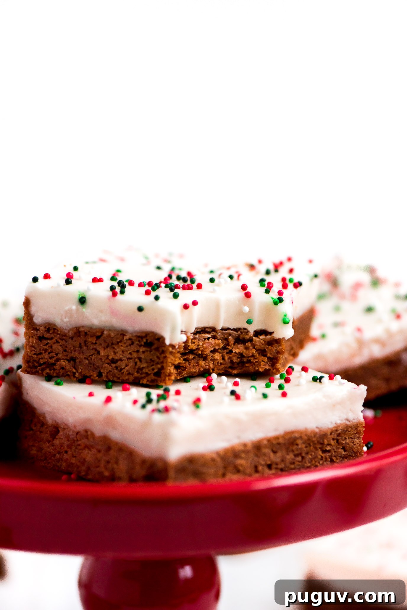 Close up of a Gingerbread Sugar Cookie Bar with a bite taken out. Close up of a soft and chewy Gingerbread Cookie Bar with a bite taken out.