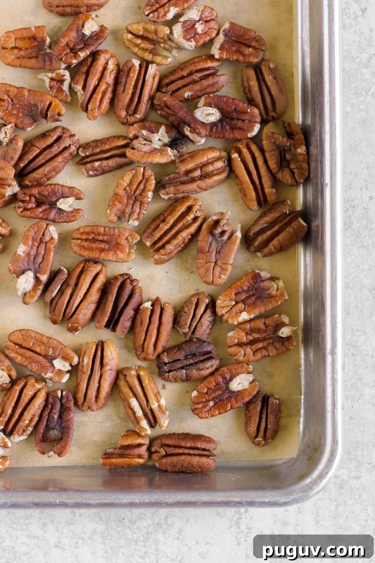Crisp Apple and Arugula Salad with Toasted Pecans 4 Roasted pecans on a baking sheet.