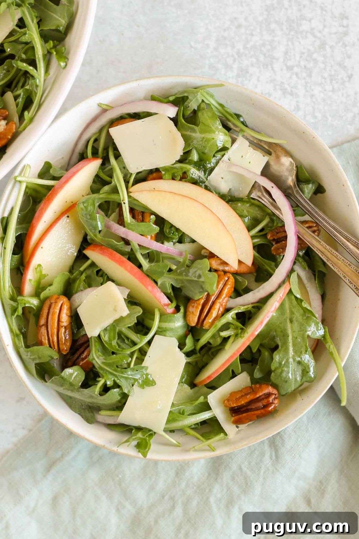 Crisp Apple and Arugula Salad with Toasted Pecans 9 Small salad bowl filled with apple arugula salad and a vintage fork.