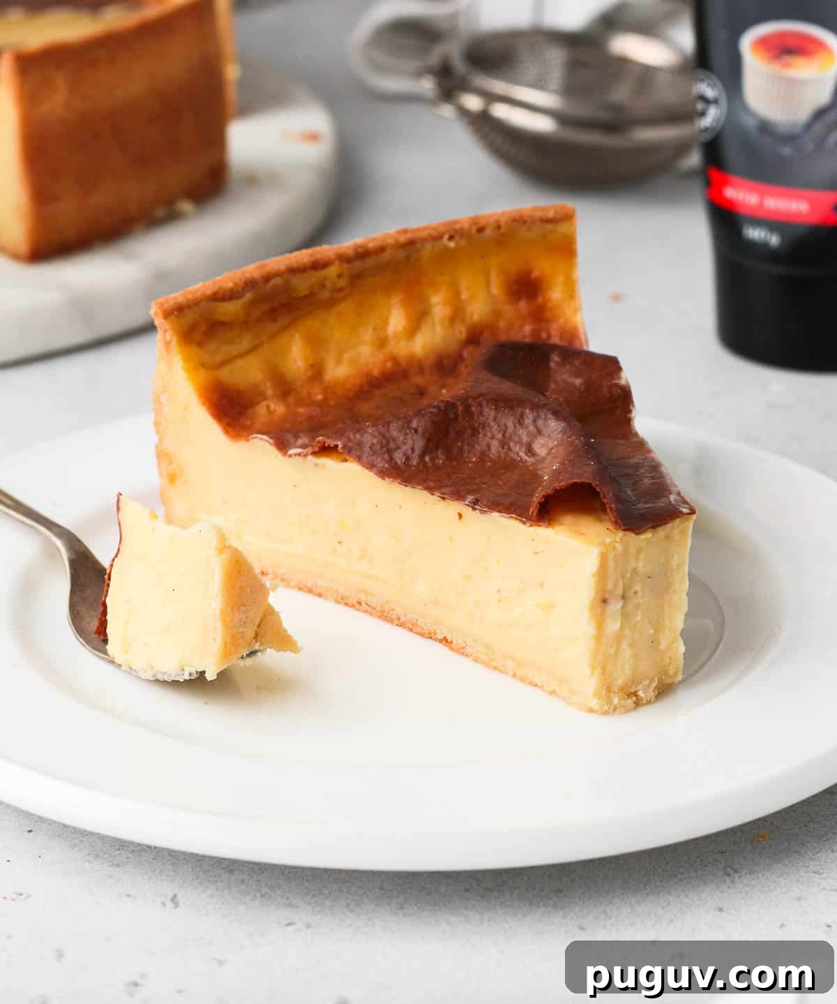 One slice of flan patissier on a white plate.