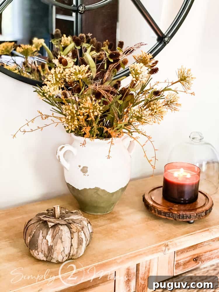 13 Stunning Ways to Add Fall Color to Your Home 16 console table with fall candle and decor