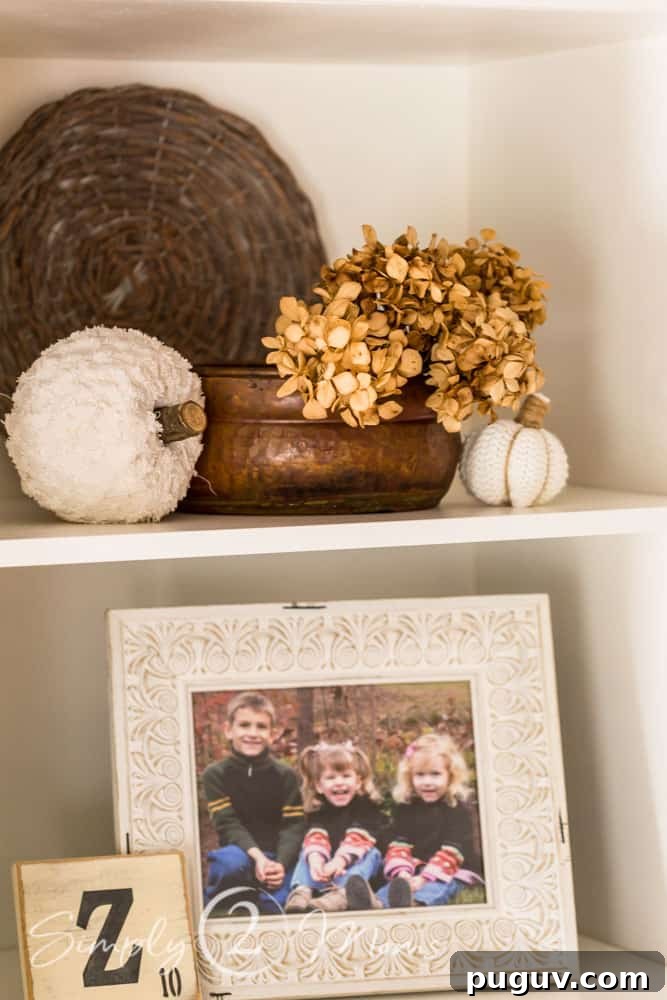 13 Stunning Ways to Add Fall Color to Your Home 19 shelf with dried hydrangeas and framed family photo