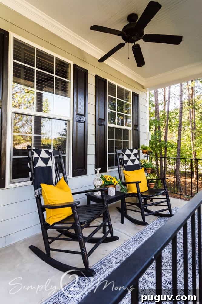 13 Stunning Ways to Add Fall Color to Your Home 4 rocking chairs on a covered front porch with pillows and throws
