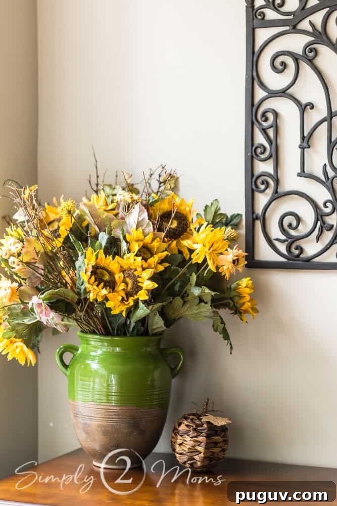 13 Stunning Ways to Add Fall Color to Your Home 6 sunflowers in pottery vase with woven pumpkin