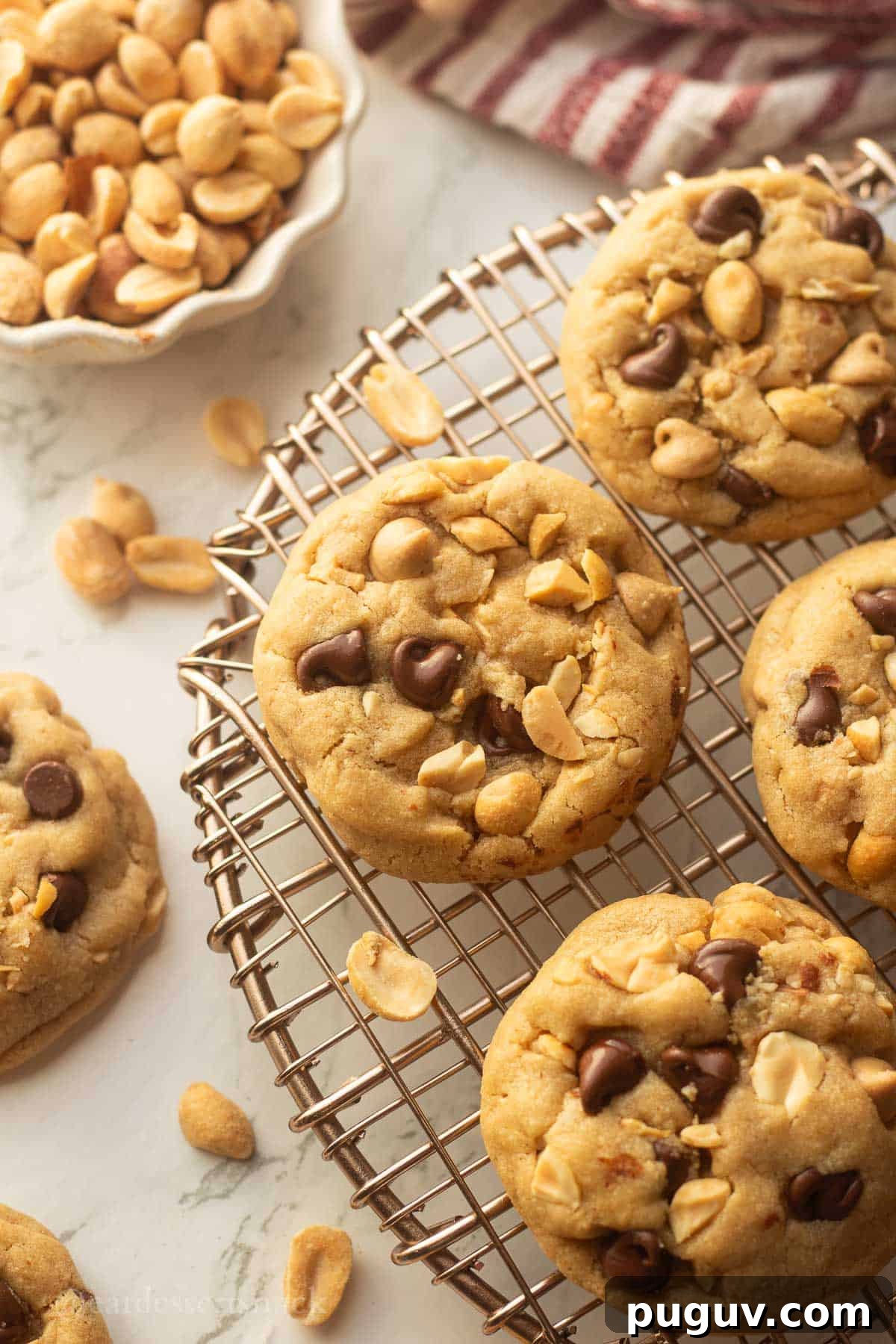 Baked peanut butter cookies on metal cooking rack.
