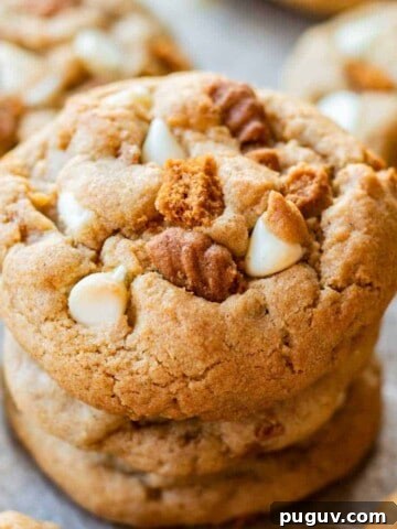 Baked white chocolate biscoff cookie stack of 3 on metal baking pan.