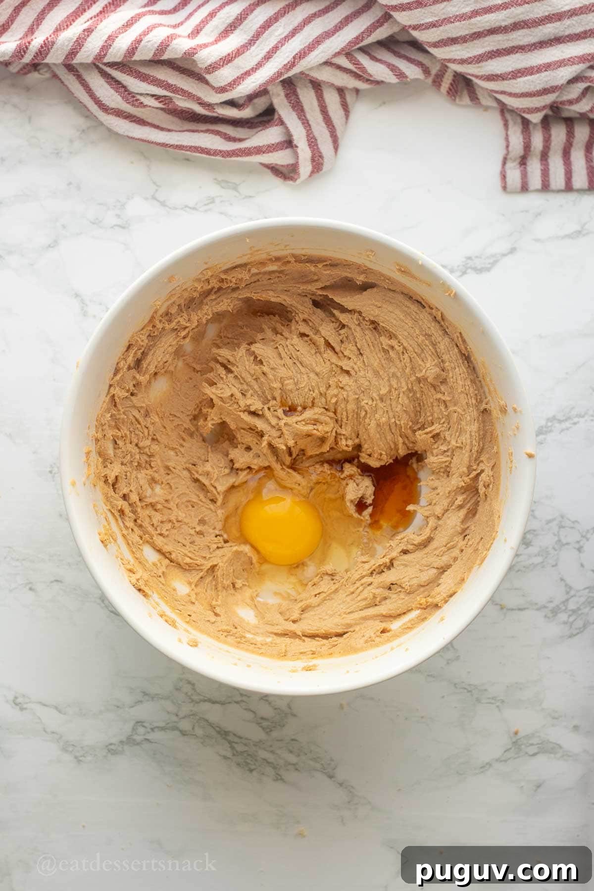Egg and vanilla in sugar and butter bowl.