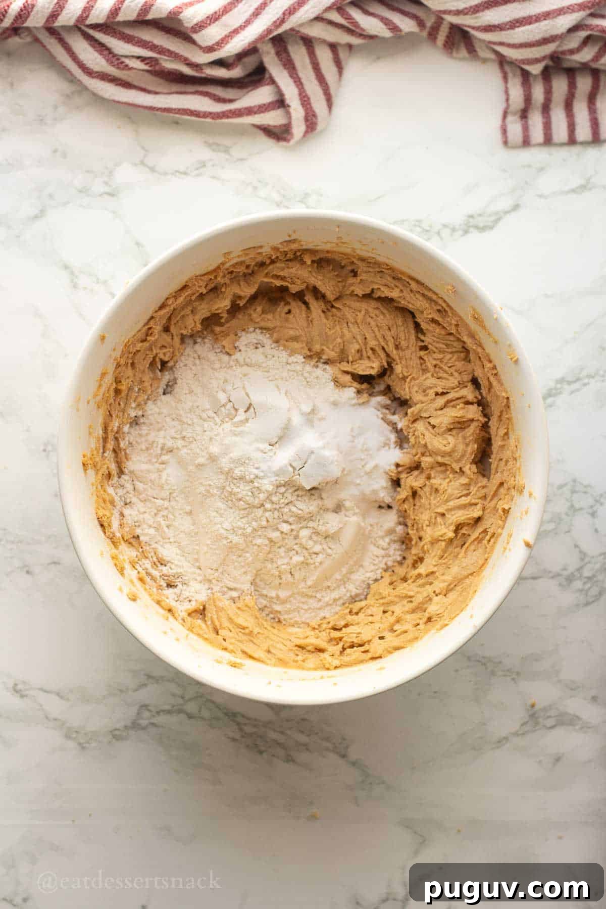 Flour and salt in bowl of cookie dough.