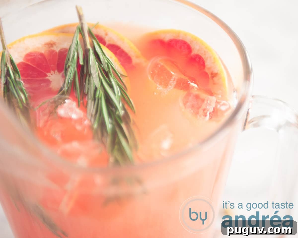 A jar of grapefruit mocktail with garnish