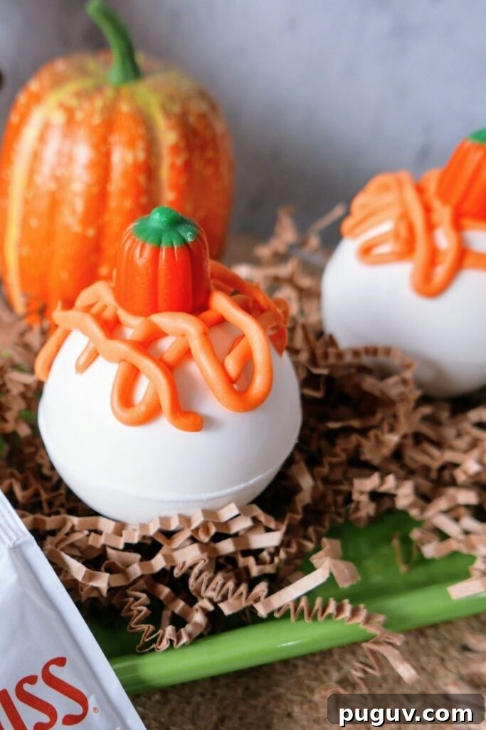 Pumpkin Spice Hot Chocolate Bombs Recipe for Cozy Fall Drinks 7 side view of hot chocolate bomb with orange icing on top