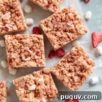 Strawberry Rice Krispie Treats Recipe — Quick No-Bake Dessert 11 Strawberry Rice Krispie Treats cut into bars, with freeze dried strawberries and mini marshmallows.