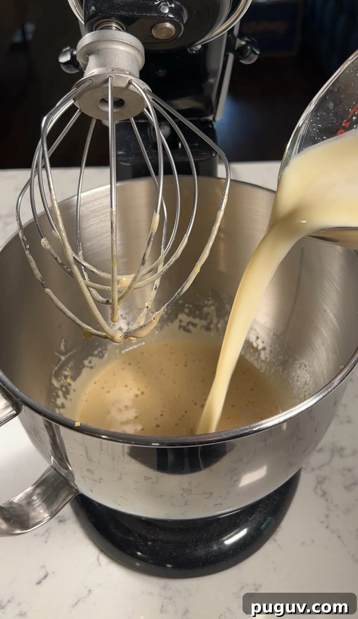 Adding wet ingredients to the cake batter.