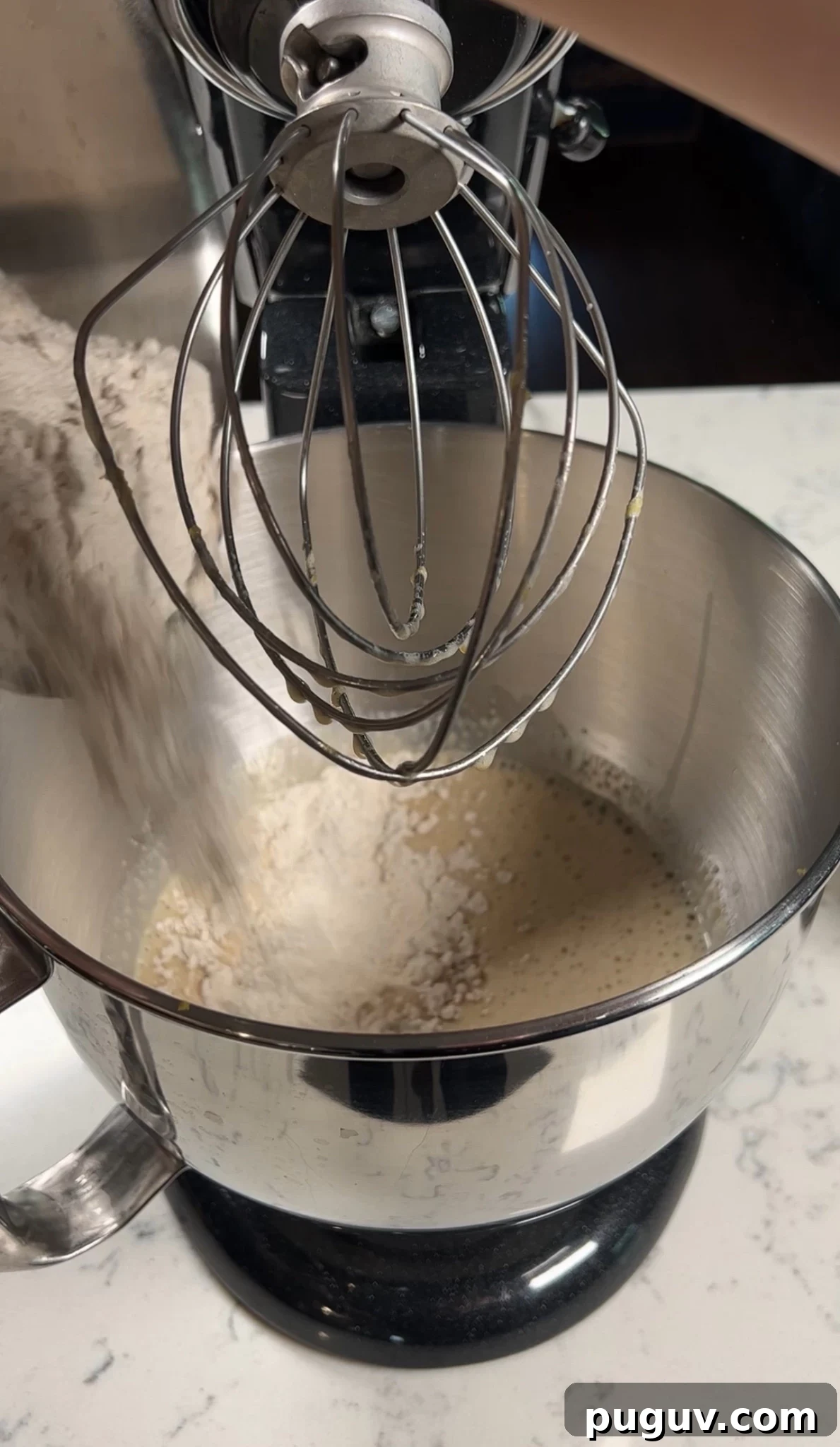 Adding dry ingredients to the cake batter.
