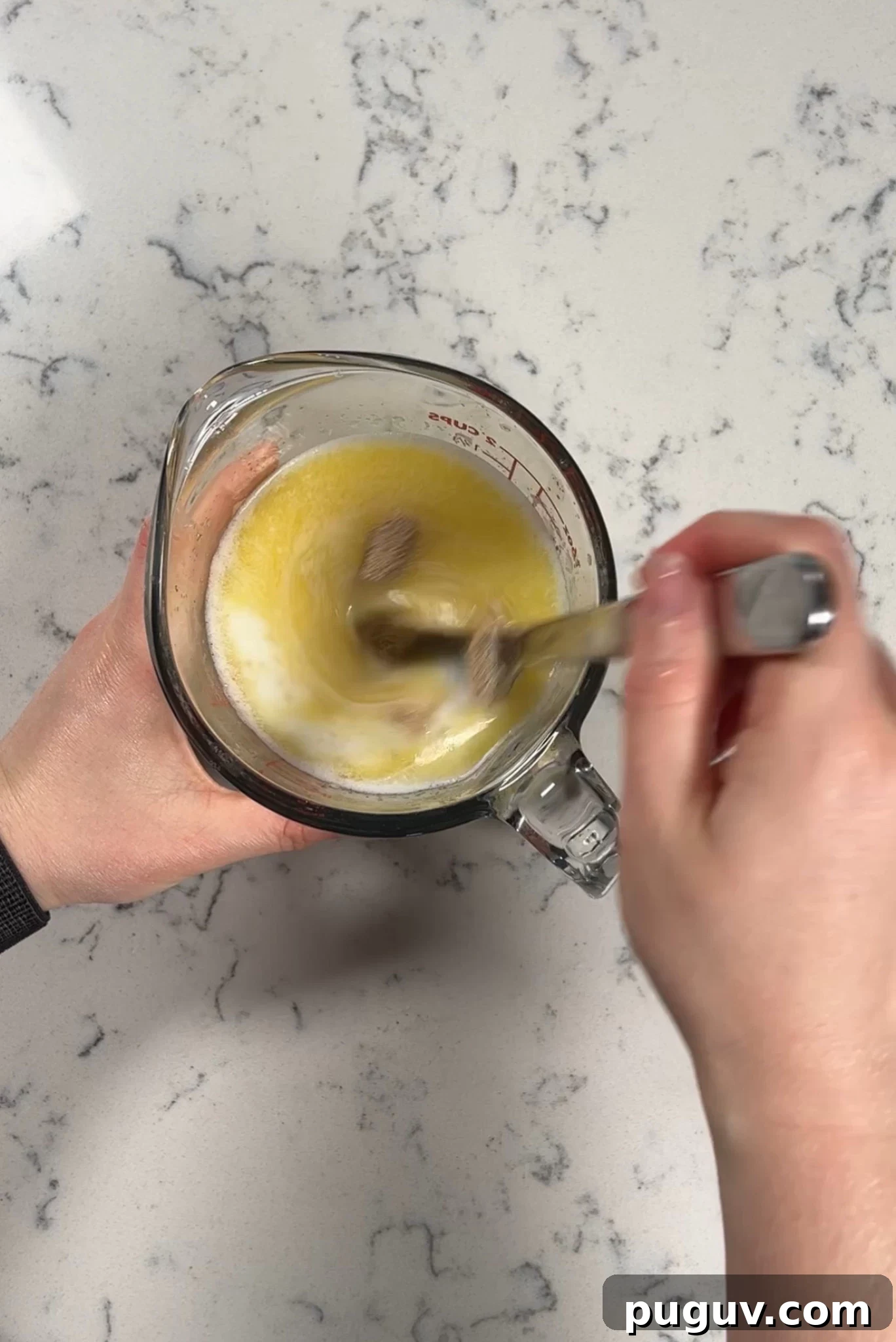 Mixing together yeast, milk, and melted butter.