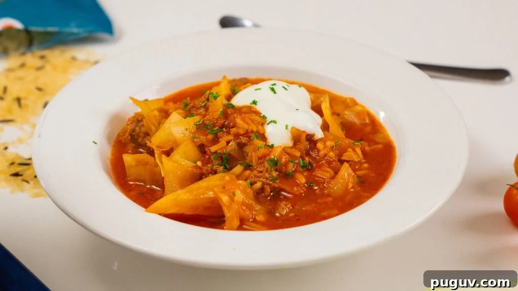 close up shot of a bowl of comforting soup. Spoon in background.