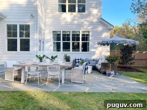 a patio makeover with a couch, umbrella and table