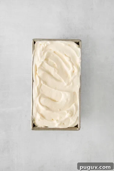 whipped cream in a metal box on a grey background.
