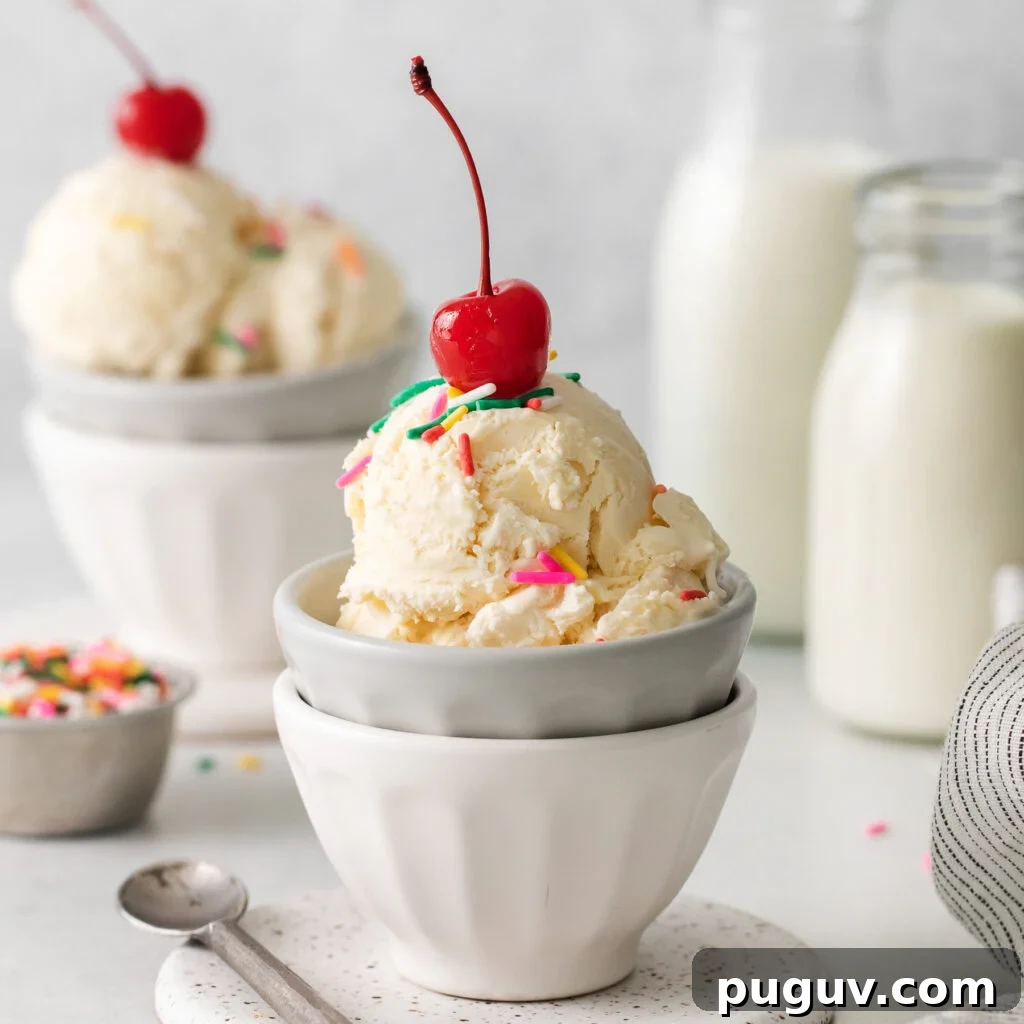 two bowls of ice cream with cherries and sprinkles.