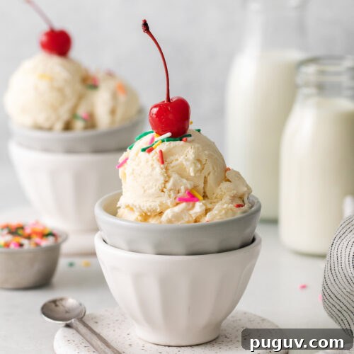 two bowls of ice cream with cherries and sprinkles.