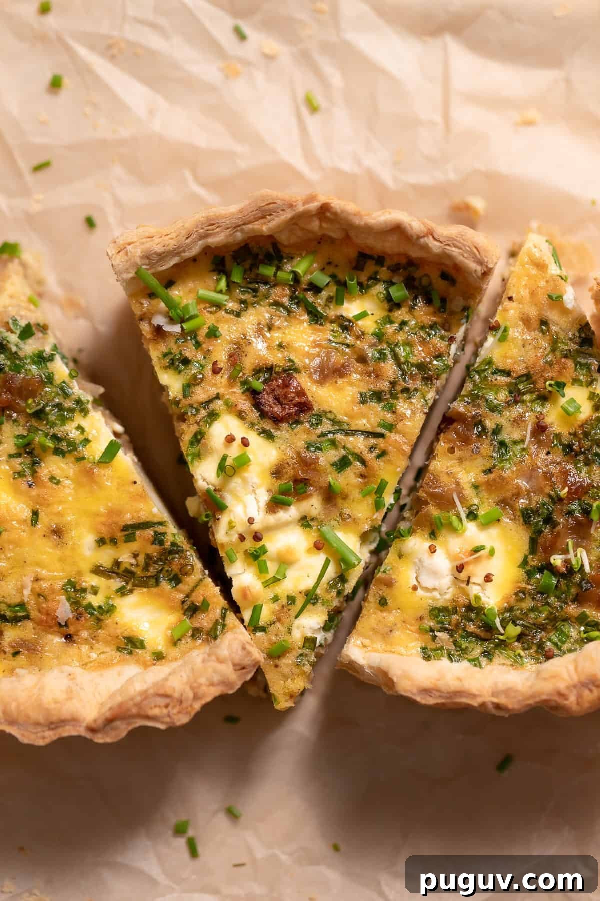 three slices of quiche on parchment paper.
