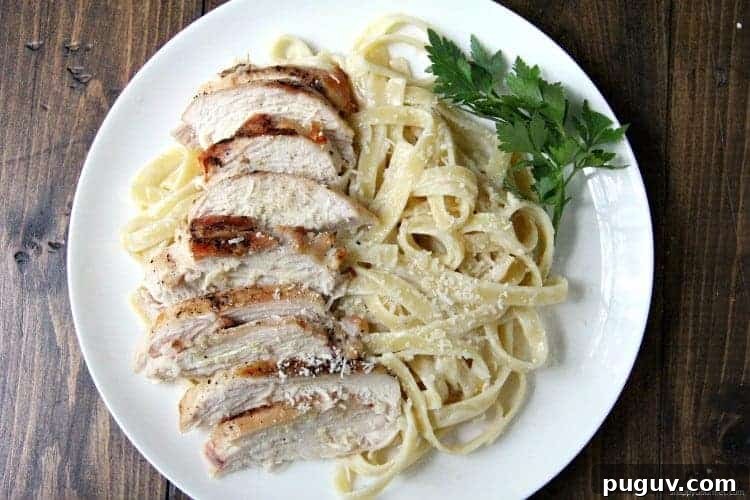 Grilled Chicken Alfredo with fettuccine on plate