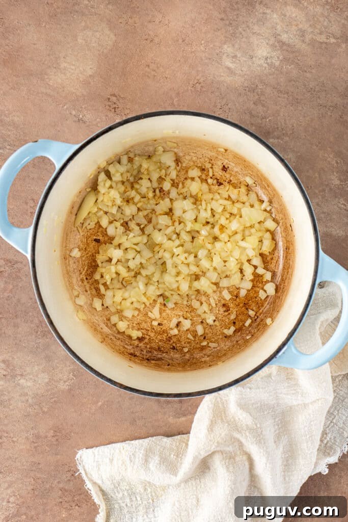 Creamy Dairy-Free Baked Potato Soup Recipe 5 Cooking off the onions and garlic in the pot.
